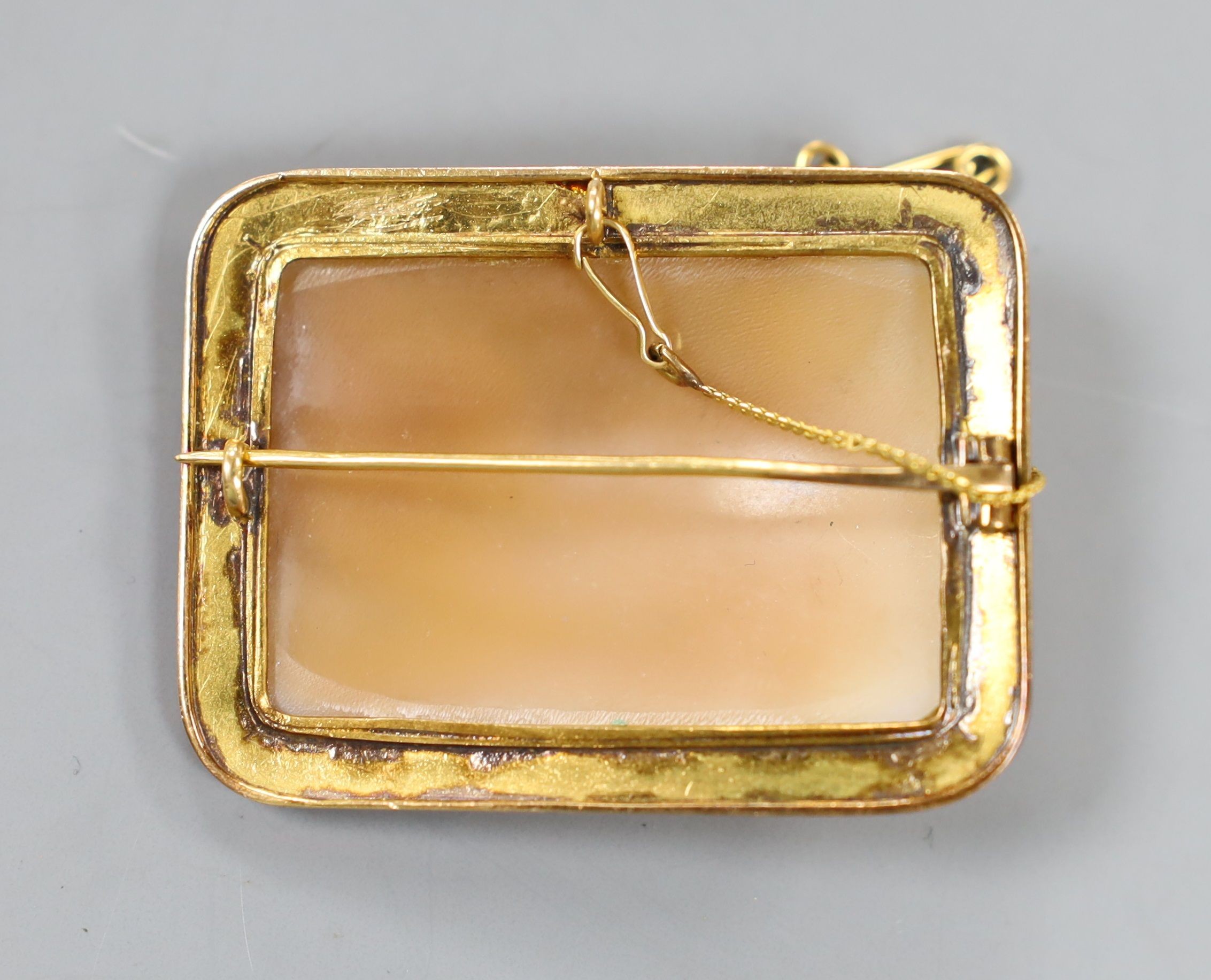 A yellow metal amounted rectangular cameo shell brooch, carved with figures cherubs and chariot, 50mm.